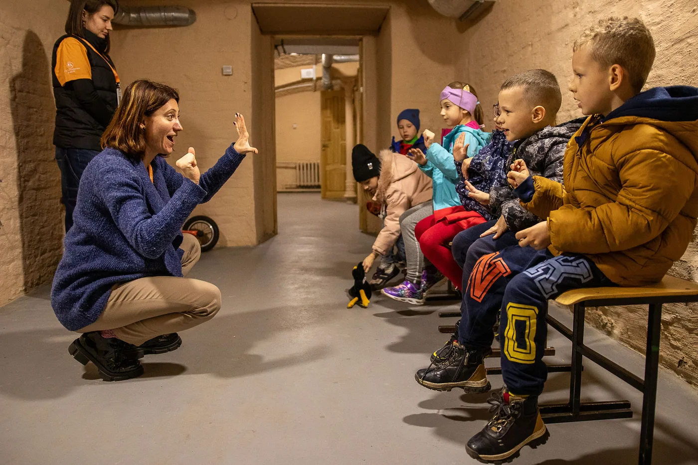 Children taking part in a guided activity inside a friendly space in a bomb shelter in Sumy, Ukraine.